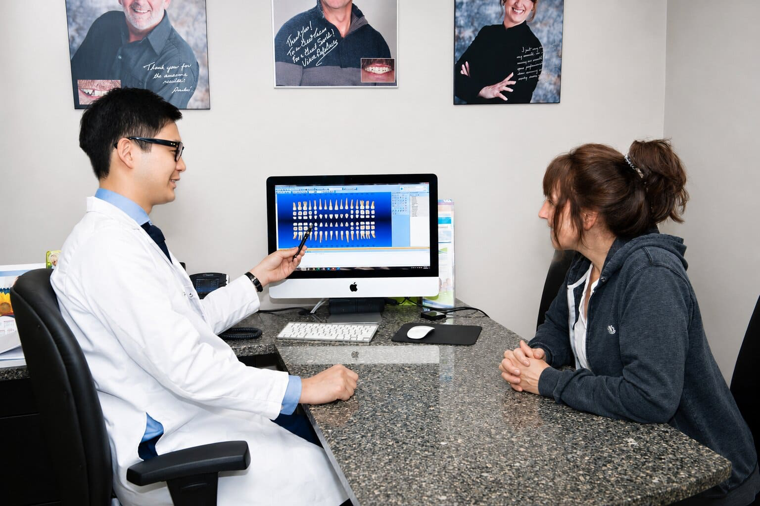 Dr. Justin Lee discussing treatment options with a patient in the consultation area